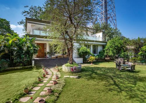 Exterior view of SaffronStays 7 Seas - 7BR pool villa with gazebo, bar & lawn, perfect for celebrations near Mandwa J