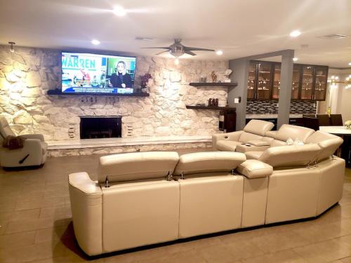 Luxury Villa, with bonus pool house, Private Pool, Hot tub, rock water fall and slide, putting green, basketball, shuffle board, play gym, privately gated on circular driveway.