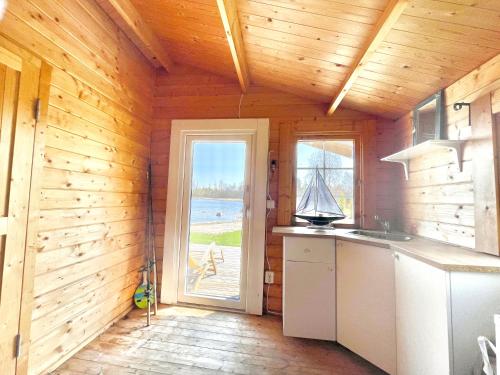 Timber house with private beach and boat including. in Norrviken