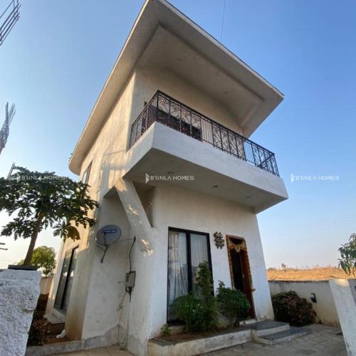 Spanish-inspired 2 BHK White Villa - Brinla Homes