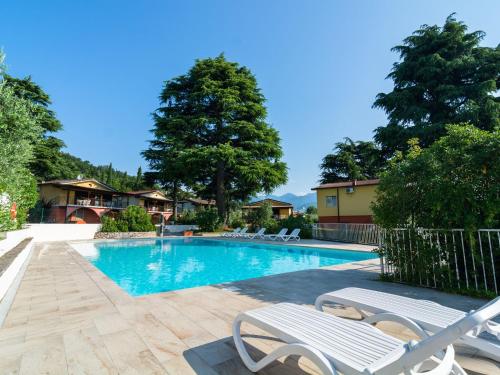 Apartment on Lake Garda with pebble beach pier for boat three swimming pools