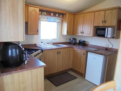 Kitchen, Waterside: Waterside Salisbury:- 6 Berth Large Wrap Around Veranda in Ingoldmells