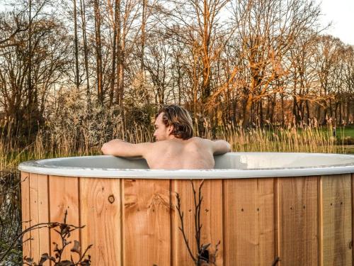 Nice chalet on the water with wood-fired hot tub, in a holiday park