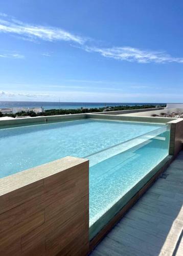 Modern Loft with Rooftop Pool & Steps from the Beach by Solmar Rentals in Playa del Carmen, Mexico