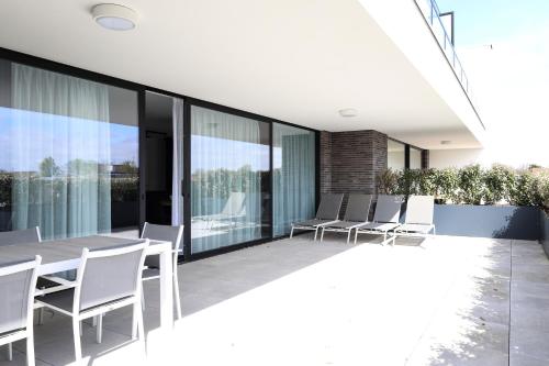 Design Apartment with 60m² terrace - heated inside pool and wellness facilities - very close to the beach