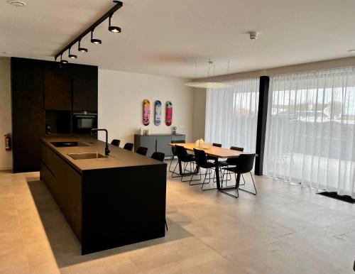 Design Apartment with 60m² terrace - heated inside pool and wellness facilities - very close to the beach