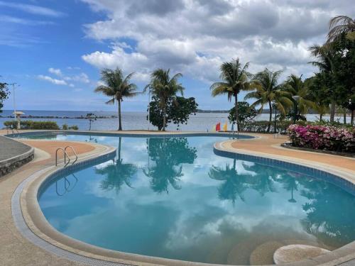Swimming pool, Modern Chic Beachfront Unit at Canyon Cove Nasugbu in Natipuan
