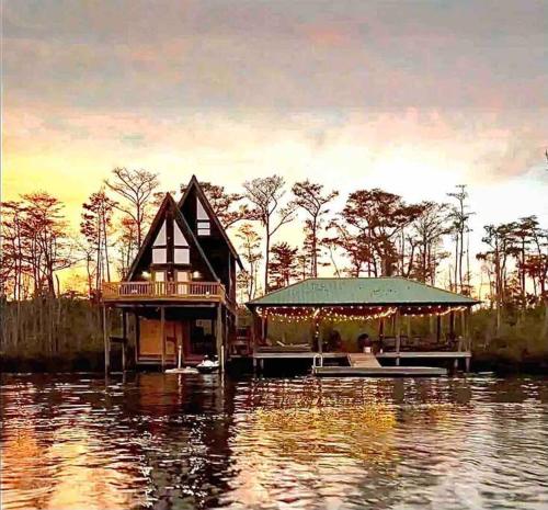Secluded cabin on the water with jet skis, kayaks, & hot tub! Pet friendly
