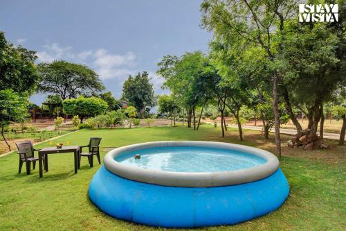 StayVista's Idyllic Farmstay - Glasshouse - Amidst Orchards with Lawn featuring a Gazebo, Splash Pool & Massage Chair