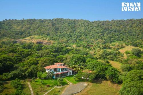 StayVista's House Below The Hill - A stylish Mountain-view villa with Pool and Games room