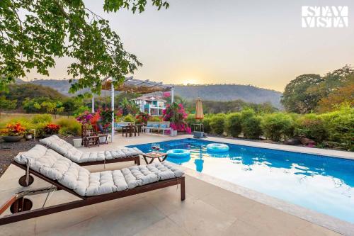 StayVista's House Below The Hill - A stylish Mountain-view villa with Pool and Games room
