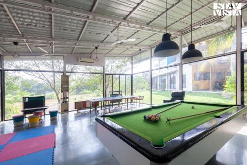 StayVista's House Below The Hill - A stylish Mountain-view villa with Pool and Games room