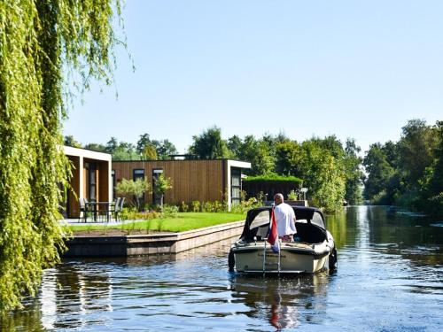 Modern holiday home on the water in a holiday park near the Loosdrechtse Plassen