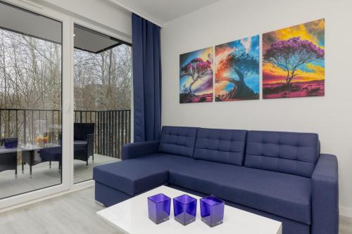 Dark Blue and Grey Apartment with Pastel Bedroom in Warsaw by Noclegi Renters, Warsaw