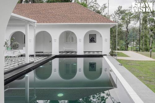 Mudra Manor- River View Villa with Comp Breakfast, Heated Pool and Jacuzzi by StayVista photo 2