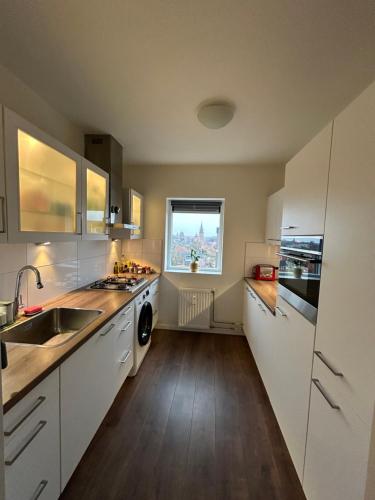Kitchen, Apartment with city skyline in Leeuwarden