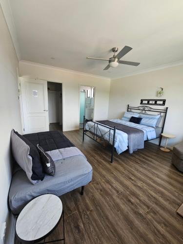 Book a spacious queen room with your own ensuite for your stay with shared laundry kitchen and living area