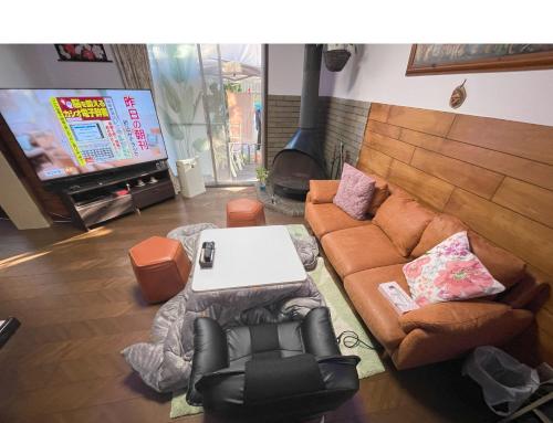 Tatami room & Living Room equipped with Multinational TV and Fire, BBQ corner in Tokyo Downtown House