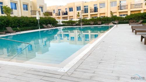 Swimming pool, Exquisite 4BR Townhouse at DAMAC Hills 2, Dubailand by Deluxe Holiday Homes in Damac Hills 2