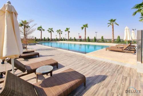Swimming pool, Exquisite 4BR Townhouse at DAMAC Hills 2, Dubailand by Deluxe Holiday Homes in Damac Hills 2