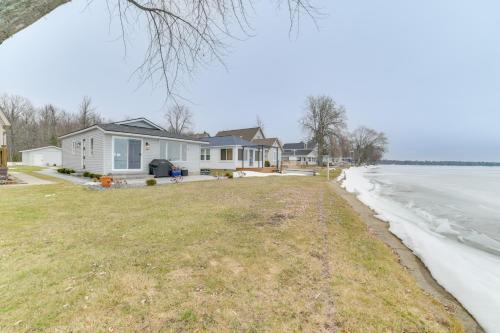 Bright Houghton Lake Home with Boat Dock and Fire Pit
