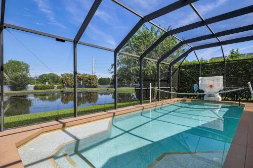 Shangri La Retreat! Lakefront private pool home with bright, tropical design!