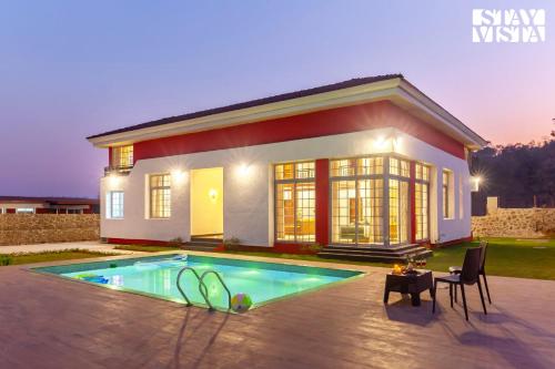 StayVista's Rustique Radiance - Hillside Retreat with Outdoor Pool & South Indian Architecture