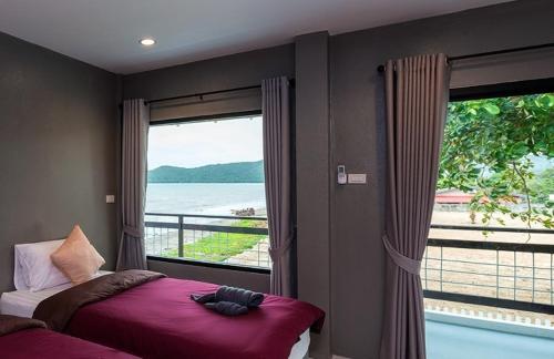 a hotel room with a view of the ocean, Kodtalay Resort in Chanthaburi