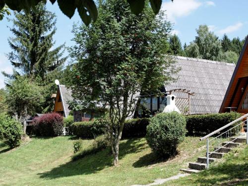 Wooden chalet with terrace near a swimming lake