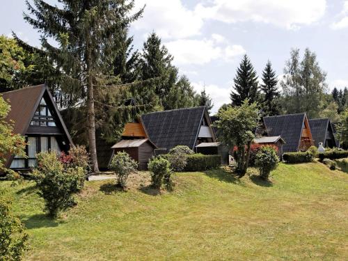 Wooden chalet with terrace near a swimming lake