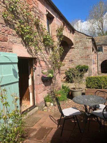 Historic converted byre in courtyard of 16C house