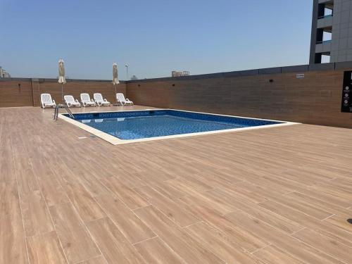 Swimming pool, Stay in the heart of Sport City in LUX 1BDR with sky view 11 in Dubai Sports City