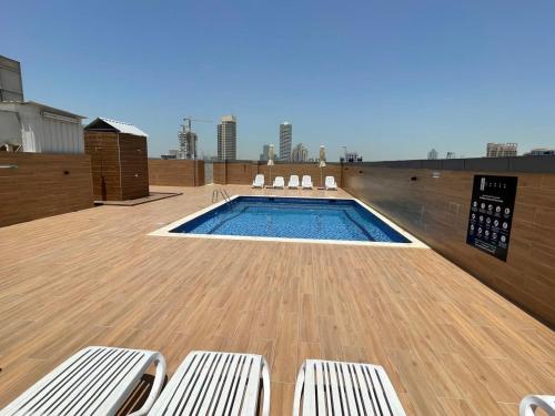 Swimming pool, Stay in the heart of Sport City in LUX 1BDR with sky view 11 in Dubai Sports City