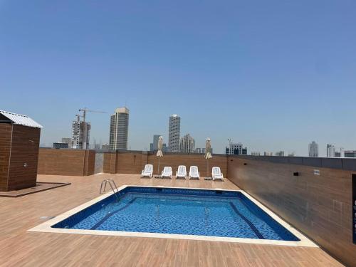 Swimming pool, Stay in the heart of Sport City in LUX 1BDR with sky view 11 in Dubai Sports City