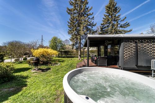 A tiny house with a garden and a hot tube