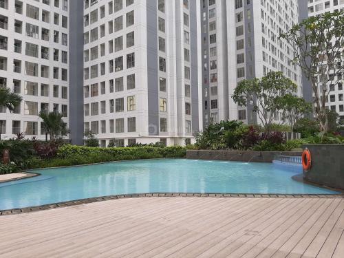 Modern and Homey 2BR Apartment at M-Town Residence By Travelio