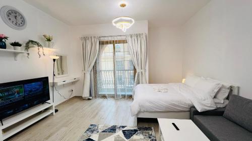 Shared lounge/TV area, Spacious Furnished studio with balcony Spain cluster International city near Dubai International City