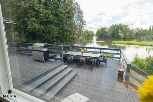 Balcony/terrace, Villa Gaia - Luxury villa with jacuzzi and beach close to trainstation 10 minutes from Tampere city! in Lempaala