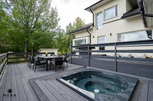 Balcony/terrace, Villa Gaia - Luxury villa with jacuzzi and beach close to trainstation 10 minutes from Tampere city! in Lempaala