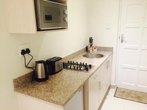 Kitchen, The Milkwood Beach Apartments in Isipingo