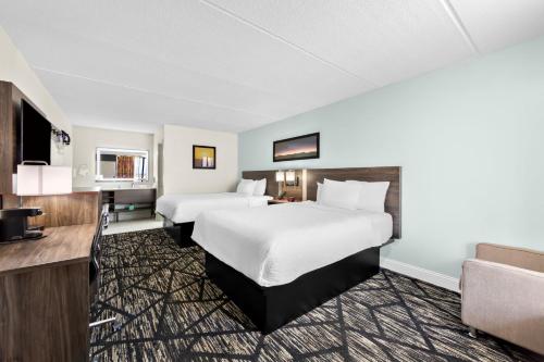 Quadruple Room with Two Queen Beds and Roll-In Shower - Disability Access/Non Smoking/Exterior Corridor room in Clarion Inn & Suites near the Leconte Center Pigeon Forge