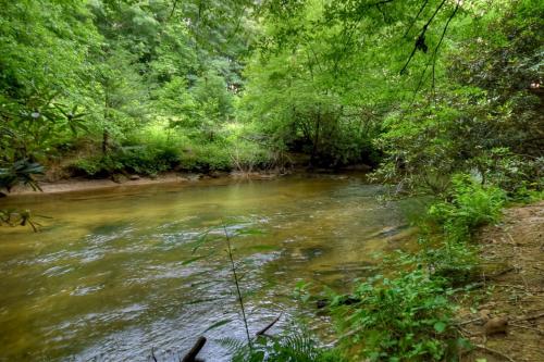 K6 Lodge Gather around the firepit soak in the hot tub and splash in the creek - image 7