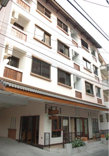 a large building with a large window, Banwiang Guest House in Chiang Mai