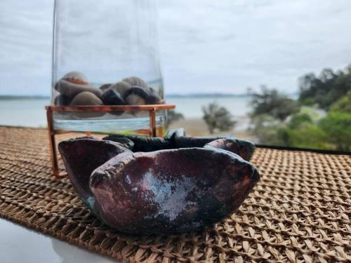 Beachfront bach w beautiful sunsets, pizza oven, handy to town in Tamaterau