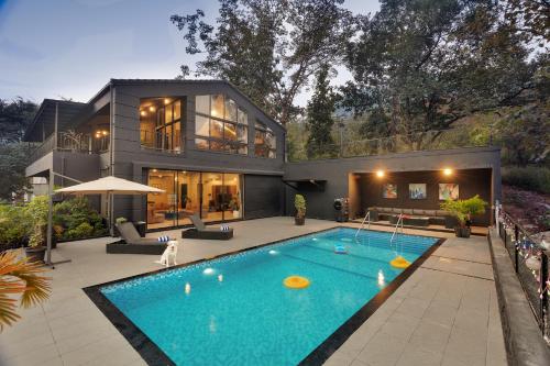 Exterior view of SaffronStays Earl Grey - 3BR pet-friendly pool villa with theatre, pool table, BBQ & glass balconies