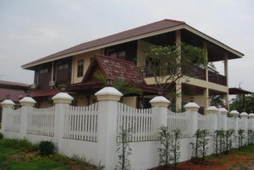 a white house with a white fence and some trees, Keerawan House Rim Khong in Nong Khai