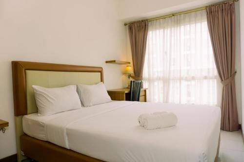 Warm and Minimalist 1BR Apartment at Scientia Residence By Travelio, Tangerang