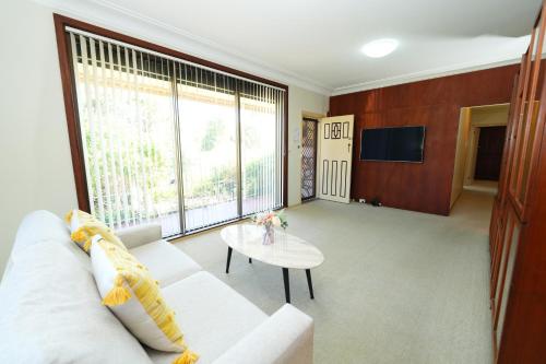 Shared lounge/TV area, 3BR Home with Pool Near Shops, M5 & Train Stations in Marrickville