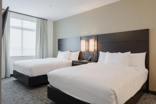 Queen Studio with Two Queen Beds and Sofa Bed image 2