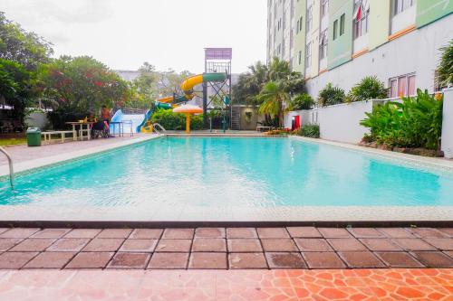 Swimming pool, Homey and Comfy 2BR at Dian Regency By Travelio near Hutan Bambu dan Taman Sakura Keputih Sukolilo